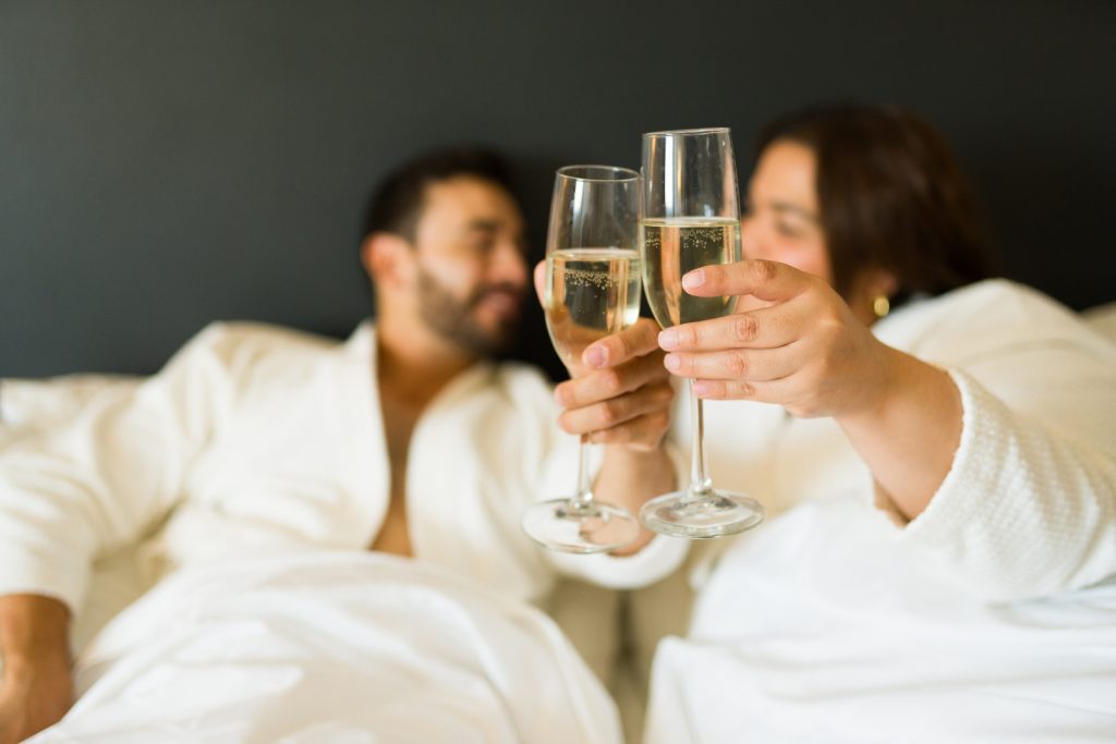 A happy couple celebrating with drinks during a romantic getaway in Branson MO