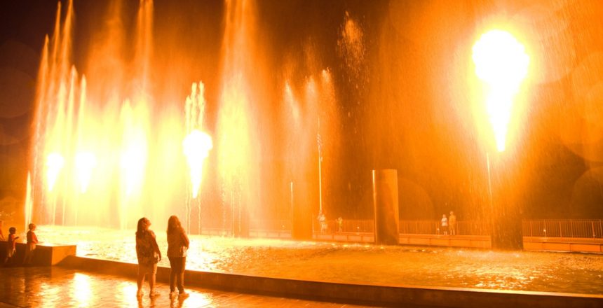 A couple share a romantic view of the Branson Landing fountain